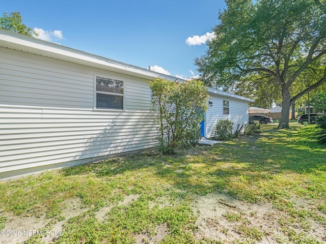 view of side of home with a lawn