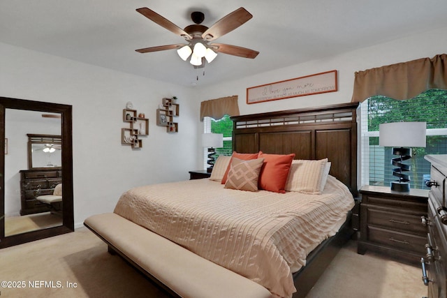 bedroom with ceiling fan and light colored carpet