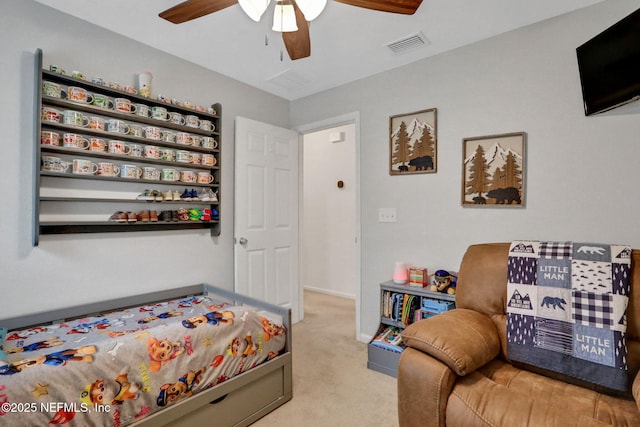 carpeted bedroom with visible vents, a ceiling fan, and baseboards