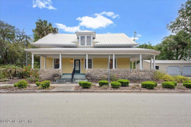 223 Rainey Ave, Saint Augustine, FL 32084 - farmhouse-style home featuring a garage, a porch, and stone siding