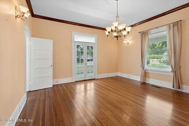 223 Rainey Ave, Saint Augustine, FL 32084 - unfurnished room featuring french doors, baseboards, wood-type flooring, a chandelier, and ornamental molding
