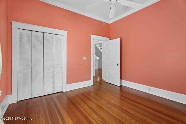 223 Rainey Ave, Saint Augustine, FL 32084 - unfurnished bedroom with ceiling fan, crown molding, wood finished floors, baseboards, and a closet
