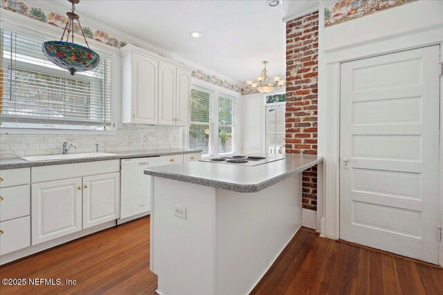 223 Rainey Ave, Saint Augustine, FL 32084 - kitchen featuring white appliances, a chandelier, a sink, and dark wood-type flooring