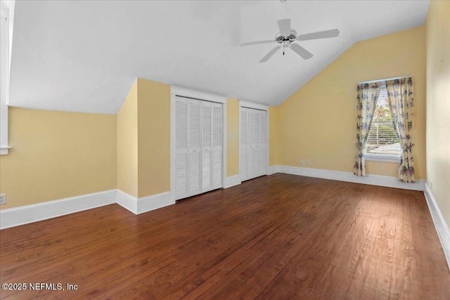 223 Rainey Ave, Saint Augustine, FL 32084 - unfurnished bedroom featuring baseboards, multiple closets, wood finished floors, and lofted ceiling
