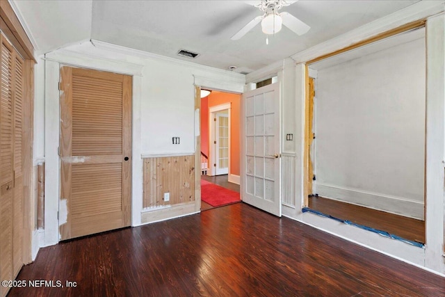 223 Rainey Ave, Saint Augustine, FL 32084 - unfurnished bedroom with ceiling fan, visible vents, wood finished floors, a wainscoted wall, and ornamental molding