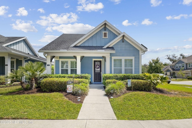 74 Lone Eagle Way, Ponte Vedra, FL 32081 - view of front of house featuring board and batten siding, a porch, and a front yard