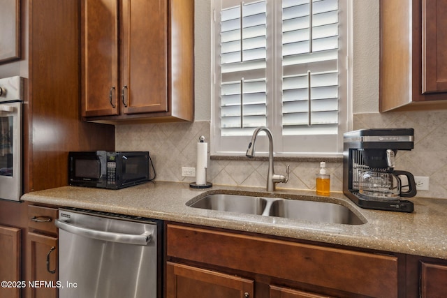 74 Lone Eagle Way, Ponte Vedra, FL 32081 - kitchen with a sink, appliances with stainless steel finishes, decorative backsplash, and light stone counters