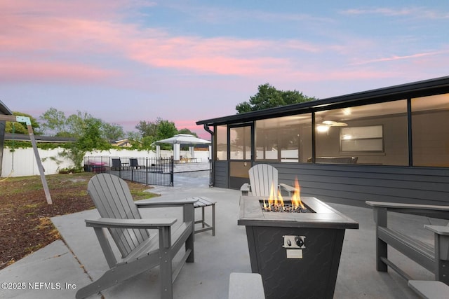 view of patio / terrace with fence and a fire pit