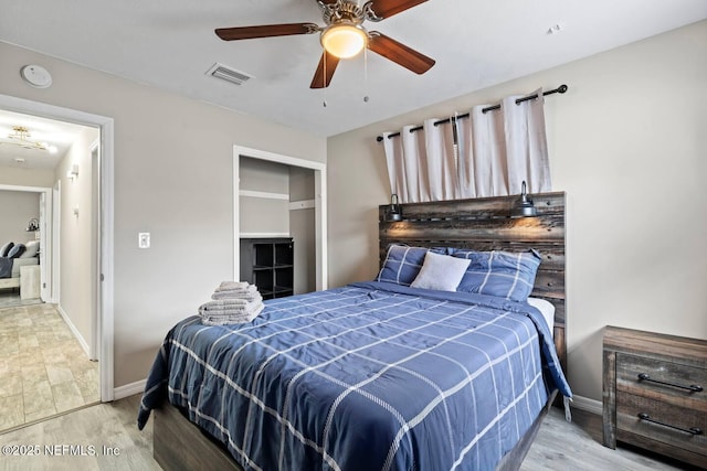 bedroom with visible vents, baseboards, ceiling fan, and wood finished floors