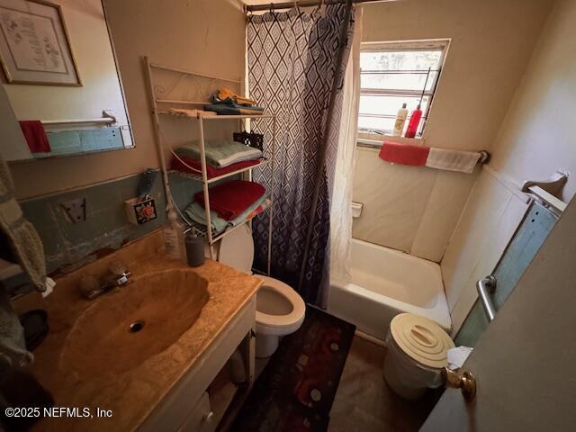 bathroom featuring vanity, toilet, and shower / bath combination with curtain