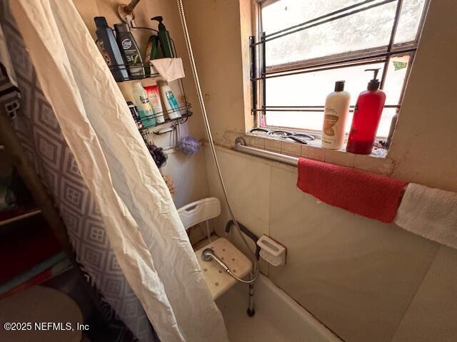 full bathroom with a shower with curtain