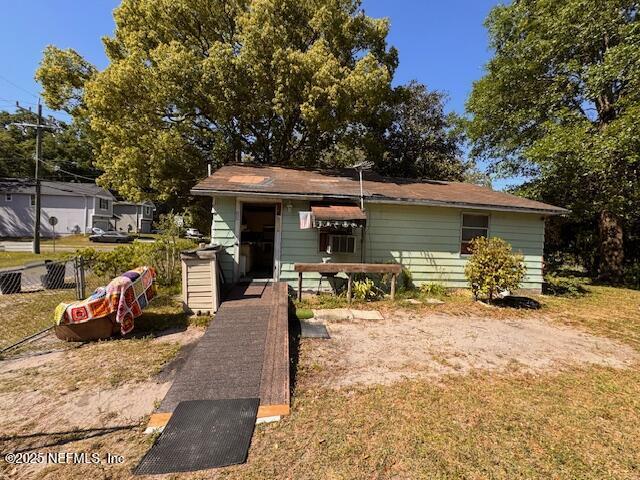 bungalow-style home featuring fence and a front yard