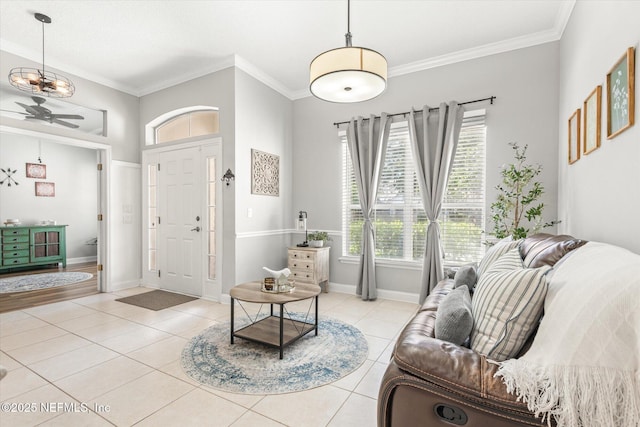 living room with a ceiling fan, light tile patterned floors, and a healthy amount of sunlight