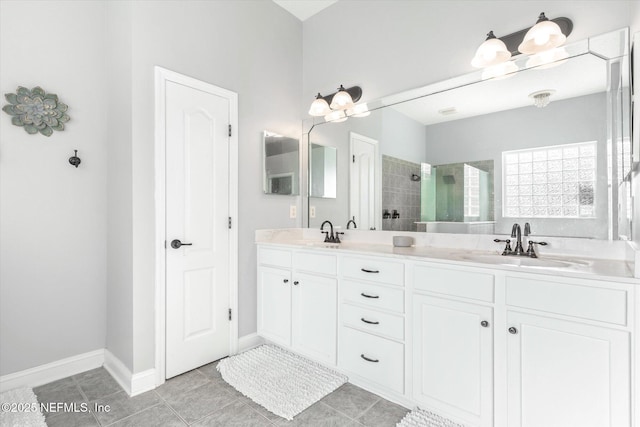 full bath with a tile shower, double vanity, a sink, and tile patterned floors