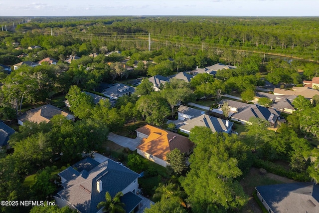 bird's eye view featuring a view of trees and a residential view