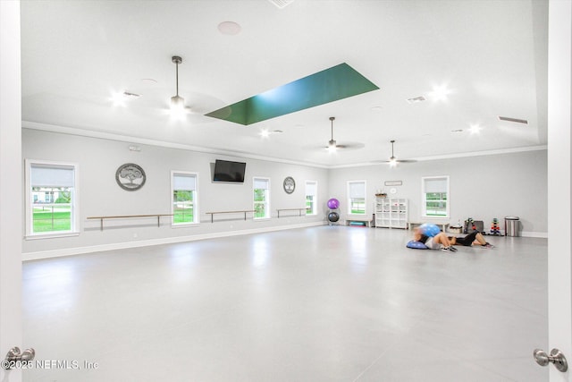gym with baseboards, visible vents, ornamental molding, and ceiling fan