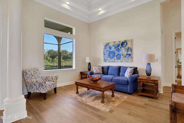 living area with crown molding, baseboards, recessed lighting, and light wood-style flooring