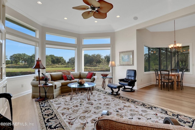 living room with crown molding, a healthy amount of sunlight, and wood finished floors