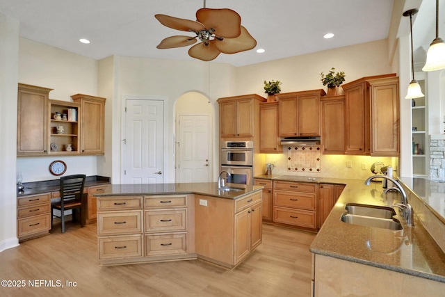 kitchen featuring open shelves, double oven, black electric cooktop, built in desk, and a sink