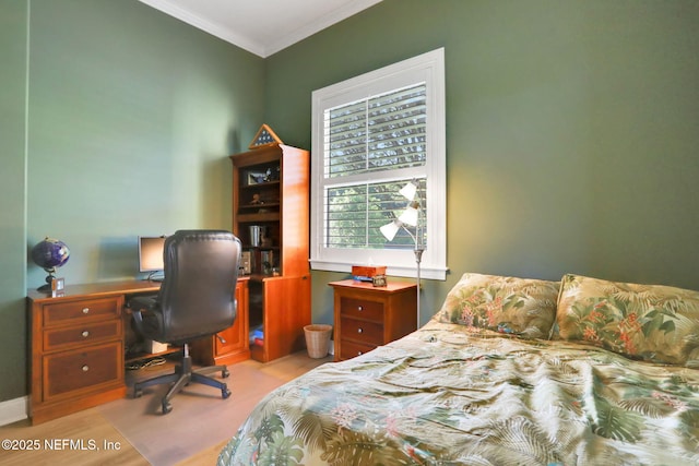bedroom featuring ornamental molding and wood finished floors