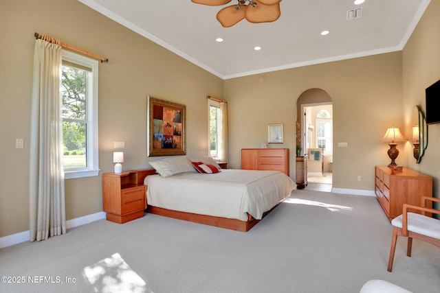 bedroom with arched walkways, baseboards, light colored carpet, and visible vents