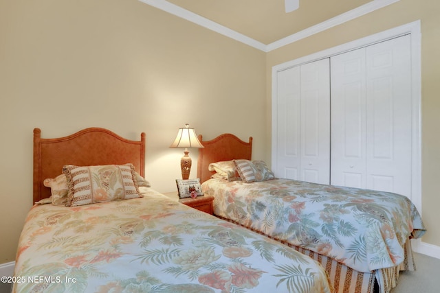 bedroom featuring ceiling fan, carpet floors, baseboards, ornamental molding, and a closet