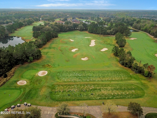 birds eye view of property with a water view and golf course view