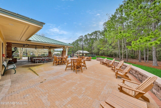 view of patio featuring outdoor dining area and a ceiling fan