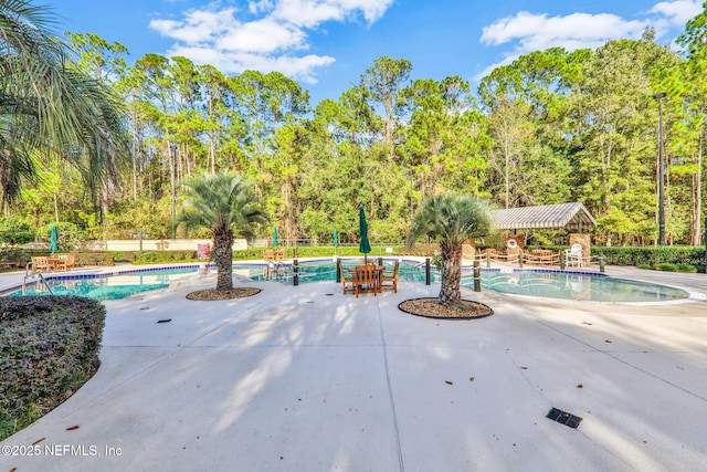pool featuring fence and a patio area