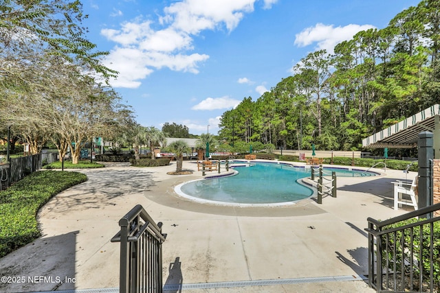 pool featuring fence and a patio