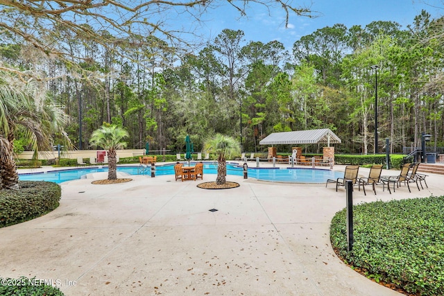 community pool featuring a patio area and fence