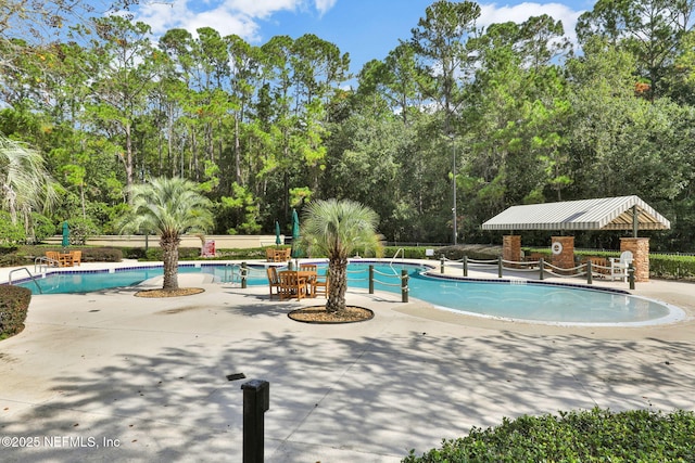 pool featuring a patio area and fence