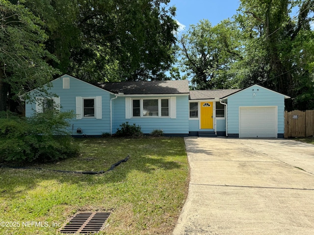 single story home with a front lawn, a garage, a shingled roof, concrete driveway, and fence