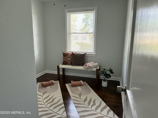 sitting room with wood finished floors and baseboards
