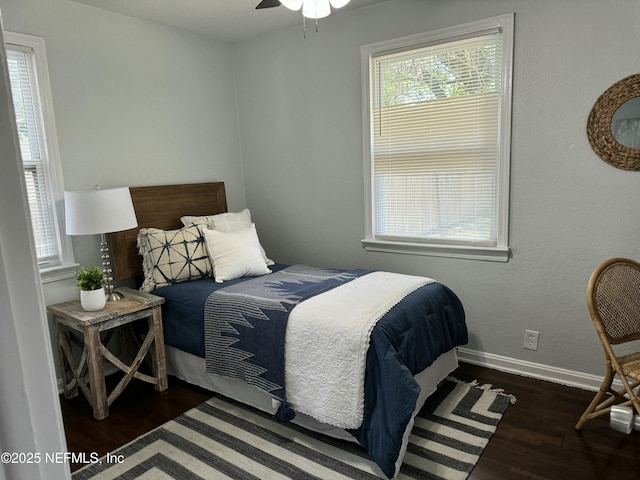 bedroom featuring wood finished floors and baseboards