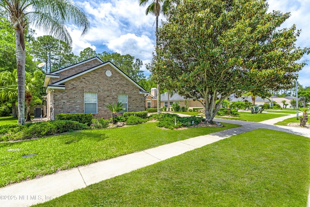 exterior space featuring brick siding and a front lawn