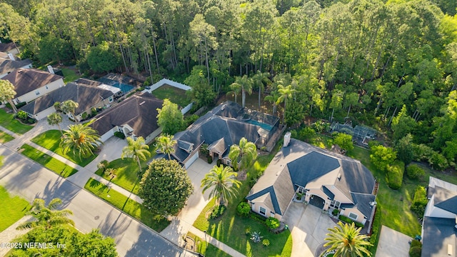birds eye view of property with a wooded view