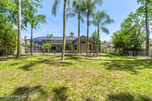 view of yard with a fenced in pool, a fenced backyard, and glass enclosure