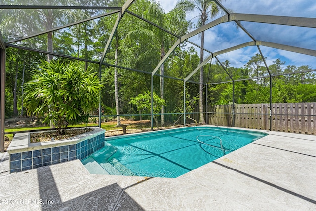 view of pool with a fenced in pool, glass enclosure, and a patio area