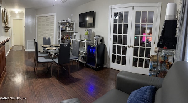 dining room featuring hardwood / wood-style floors, french doors, and visible vents