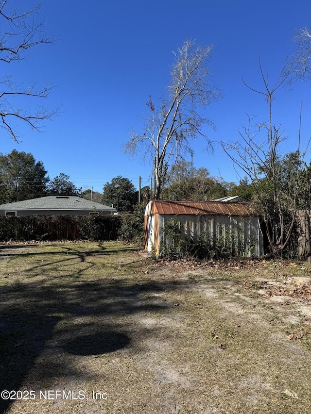 view of yard with a storage unit and an outdoor structure