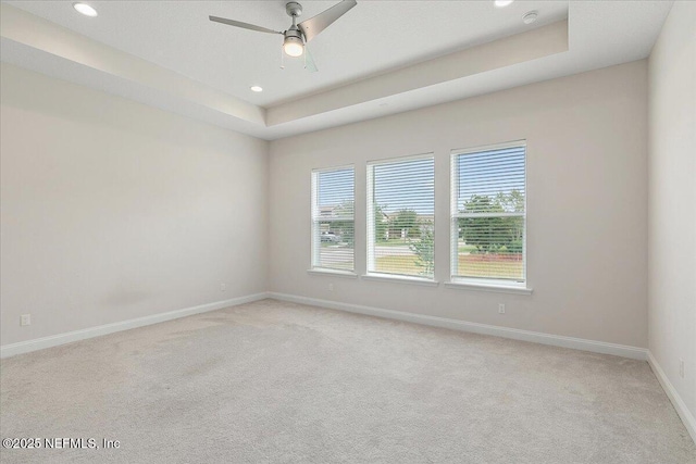 spare room with baseboards, recessed lighting, a ceiling fan, and light colored carpet