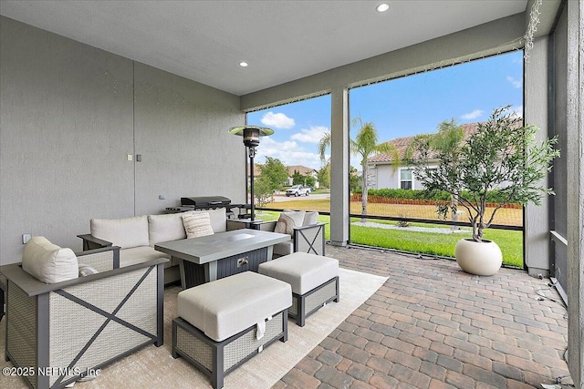 sunroom featuring outdoor lounge area
