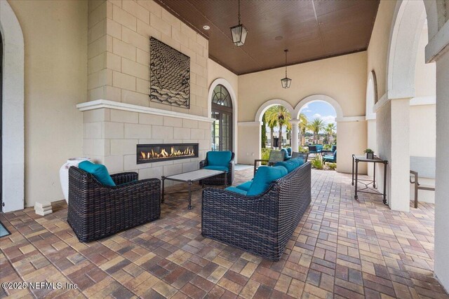 view of patio / terrace featuring an outdoor living space with a fireplace