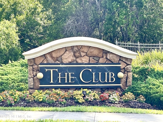 community sign featuring fence
