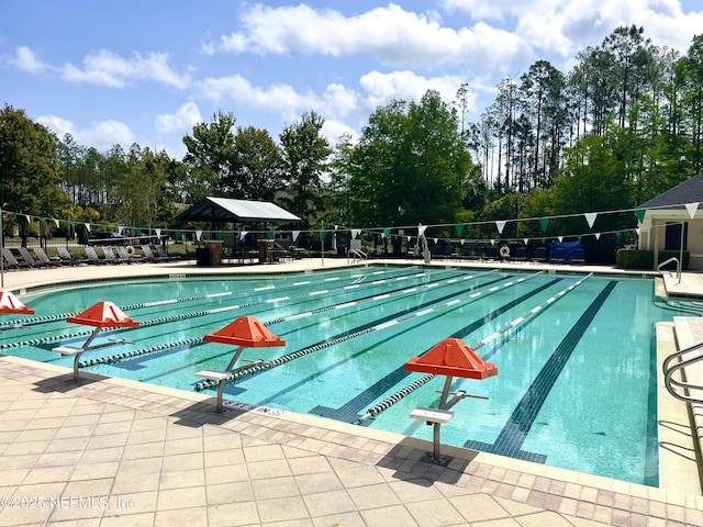 pool featuring a patio area and fence