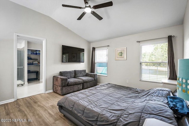 bedroom with multiple windows, a ceiling fan, vaulted ceiling, and wood finished floors