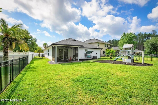 rear view of house featuring central AC, a fenced backyard, a sunroom, a playground, and a yard