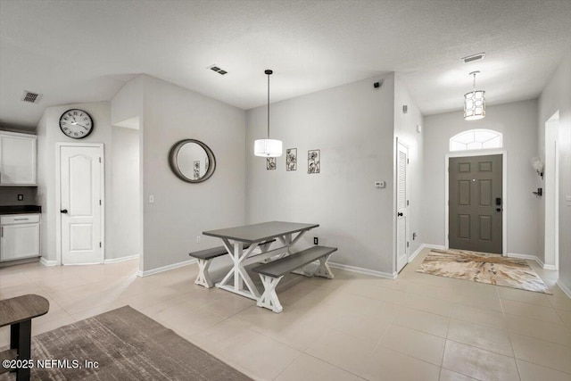 entryway with baseboards, light tile patterned flooring, and visible vents
