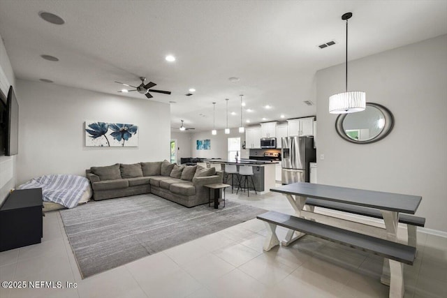 living room with visible vents, recessed lighting, ceiling fan, and light tile patterned floors